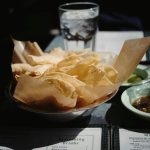 Crunchy tortilla chips served with salsa, perfect for a Tex-Mex dining experience.